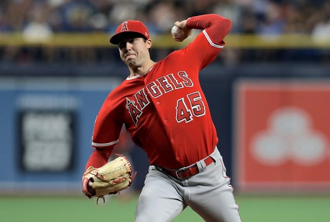 FILE - In this June 13, 2019 file photo Los Angeles Angels' Tyler Skaggs pitches to the Tampa Bay Rays during the first inning of a baseball game in St. Petersburg, Fla. Tyler Skaggs has died at age 27, Monday, July 1, 2019. Skaggs started the Angels' game Saturday night against the Athletics. Their game against the Texas Rangers on Monday night has been postponed. (AP Photo/Chris O'Meara, file)