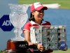 FILE - In this Nov. 19, 2006 file photo Julieta Granada, of Paraguay, stands next to her trophy as she holds a box of money after winning the LPGA ADT Championship at the Trump International Golf Club in West Palm Beach, Fla. The format this year allows any of the 60 players to win the $1.5 million prize by winning the CME Group Tour Championship. (AP Photo/Lynne Sladky, file)