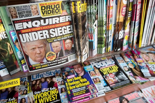 FILE - In this July 12, 2017 file photo, an issue of the National Enquirer featuring President Donald Trump on its cover is displayed on a newsstand in a store in New York. The tabloid's owner, American Media announced Thursday, April 18, 2019, that it is selling the supermarket weekly to James Cohen, the former head of the airport newsstand company Hudson News. (AP Photo/Mary Altaffer, File)
