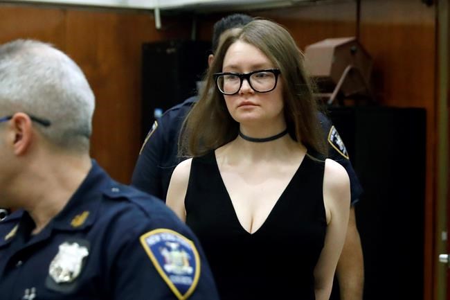 Anna Sorokin arrives in New York State Supreme Court for her trial on grand larceny charges, in New York, Wednesday, March 27, 2019. She is on trial on grand larceny and theft of services charges alleging she swindled $275,000 in a 10-month odyssey that saw her jetting to Omaha and Marrakesh. (AP Photo/Richard Drew)