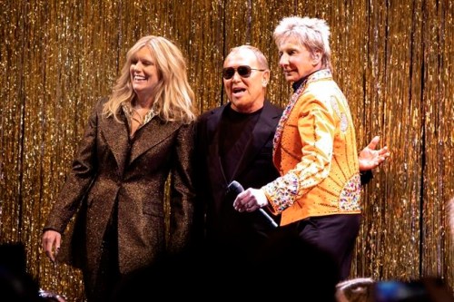 Designer Michael Kors, center, is joined by model Patti Hansen and Barry Manilow on stage after his collection was modeled during Fashion Week in New York, Wednesday, Feb. 13, 2019. (AP Photo/Richard Drew)
