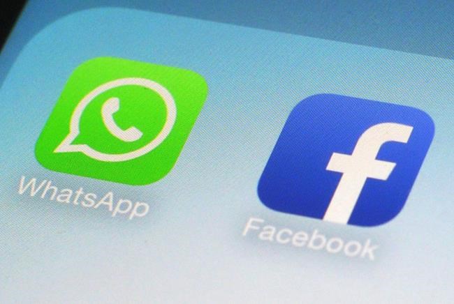 FILE - This Feb. 19, 2014, file photo, shows WhatsApp and Facebook app icons on a smartphone in New York. Is Big Tech headed for a big breakup? Federal regulators are already investigating Facebook's privacy practices. And the antitrust question has been rumbling in the background, with critics calling for spinning off WhatsApp and Instagram. (AP Photo/Patrick Sison, File)