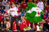 File-This Sept. 16, 2013. file photo shows the Phillies Phanatic dancing with a fan on the dugout during the eighth inning of a baseball game in Philadelphia. The Philadelphia Phillies have sued the New York company that created the Phanatic mascot to prevent the green fuzzy fan favorite from becoming a free agent. In a complaint filed Friday, Aug. 2, 2019, in U.S. District Court in Manhattan, the team alleged Harrison/Erickson threatened to terminate the Phillies' rights to the Phanatic next year and “make the Phanatic a free agent” unless the team renegotiated its 1984 agreement to acquire the mascot’s rights. (AP Photo/Chris Szagola, File)