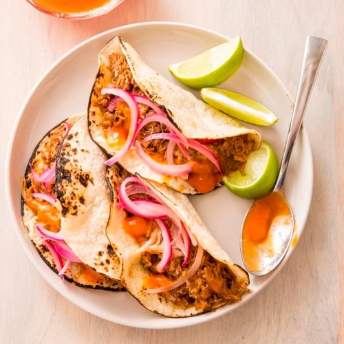 This undated photo provided by America's Test Kitchen in January 2019 shows Citrus-Braised Pork Tacos in Brookline, Mass. This recipe appears in the book 