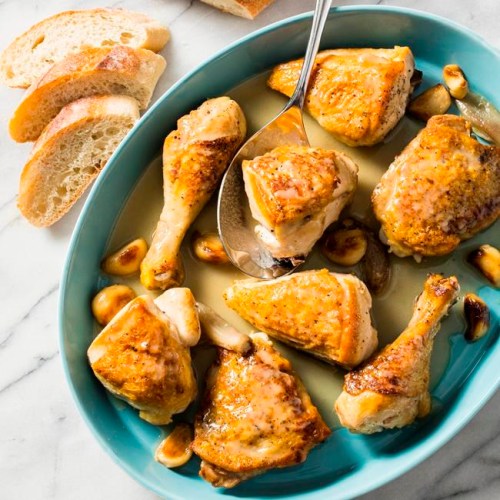This undated photo provided by America's Test Kitchen in March 2019 shows Chicken With 40 Cloves Of Garlic. The recipe appears in the cookbook 