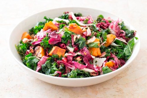 This undated photo provided by America's Test Kitchen in March 2019 shows Kale Salad With Sweet Potatoes. The recipe appears in the cookbook 