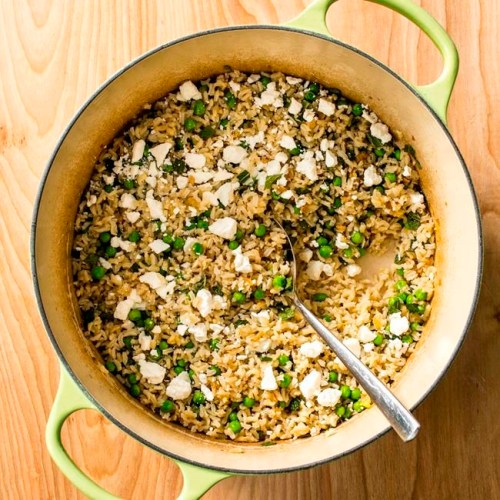 This undated photo provided by America's Test Kitchen in April 2019 shows Brown Rice Pilaf with Peas, Feta and Mint in Brookline, Mass. This recipe appears in the book ‚ÄúCook It in Your Dutch Oven.‚Äù (Steve Klise/America's Test Kitchen via AP)