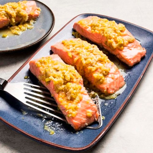 This undated photo provided by America's Test Kitchen in May 2019 shows Salmon with Leeks and White Wine in Brookline, Mass. This recipe appears in the cookbook ‚ÄúHow to Braise Everything.‚Äù (Carl Tremblay/America's Test Kitchen via AP)