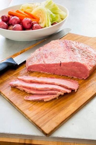 This undated photo provided by America's Test Kitchen in March 2019 shows home corned beef and cabbage. The recipe appears in the cookbook 