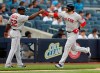Boston Red Sox's J.D. Martinez, right, celebrates his solo home run with third base coach Carlos Febles during the first inning of a baseball game against the New York Yankees, Sunday, June 2, 2019, in New York. (AP Photo/Kathy Willens)