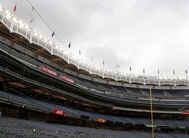 Rain clouds gather over Yankee Stadium after a baseball game between the New York Yankees and the Baltimore Orioles was postponed due to inclement weather, Tuesday, May 14, 2019, in New York. This follows the postponement of Monday's game between the two teams due to unplayable field conditions from excess rainwater pooling in the outfield. (AP Photo/Kathy Willens)