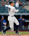 New York Yankees' Aaron Judge watches his solo home run during the first inning of the team's baseball game against the Toronto Blue Jays, Tuesday, June 25, 2019, in New York. It was Judge's first home run since returning from a stint on the injured list. (AP Photo/Kathy Willens)