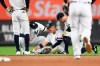 New York Yankees second baseman Gleyber Torres sits on the ground after slipping while trying to field a ground ball during the fourth inning of the team's baseball game against the Toronto Blue Jays, Friday, Sept. 20, 2019, in New York. (AP Photo/Sarah Stier)