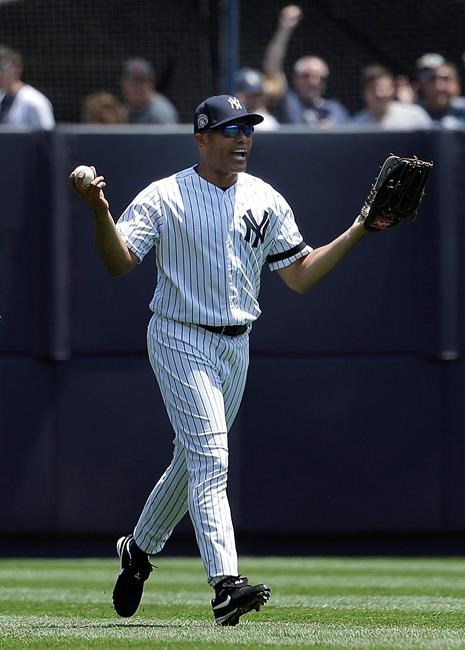 Former New York Yankees player Mariano Rivera reacts after catching a fly ball in the outfield during the Old Timers' Day game at Yankee Stadium, Sunday, June 23, 2019, in New York. (AP Photo/Seth Wenig)