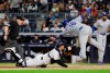 New York Yankees catcher Kyle Higashioka, center, tags out Kansas City Royals' Martin Maldonado at home plate as referee James Williams, left, watches during the third inning of a baseball game Friday, April 19, 2019, in New York. (AP Photo/Frank Franklin II)