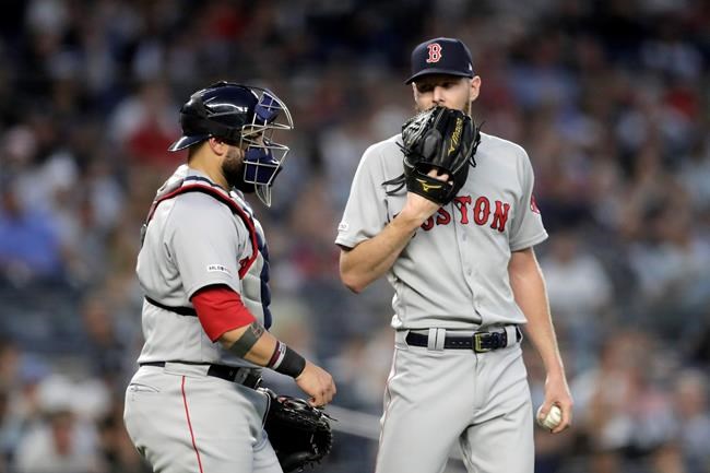 Boston Red Sox starting pitcher Chris Sale, right, talks to catcher Sandy Leon during the fourth inning of the team's baseball game against the New York Yankees, Friday, May 31, 2019, in New York. (AP Photo/Julio Cortez)