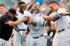 The New York Yankees celebrate with Mike Ford, center, after he hit a walk-off, pinch-hit, solo home run during a baseball game against the Oakland Athletics, Sunday, Sept. 1, 2019, in New York. The Yankees won 5-4. (AP Photo/Kathy Willens)
