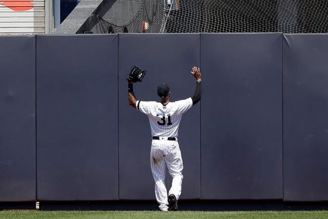 New York Yankees center fielder Aaron Hicks reacts as Colorado Rockies' Trevor Story hits a two-run double during the fourth inning of a baseball game at Yankee Stadium, Sunday, July 21, 2019, in New York. (AP Photo/Seth Wenig)