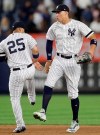 New York Yankees' second baseman Gleyber Torres (25), and right fielder Aaron Judge celebrate the Yankees' 4-1 victory over the Texas Rangers in a baseball game Wednesday, Sept. 4, 2019, in New York. Both Torres and Judge hit home runs in the game. (AP Photo/Kathy Willens)