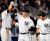 New York Yankees' Brett Gardner, left celebrates with the Mike Tauchman after Tauchman hit a sixth-inning, three-run home run off Boston Red Sox's Erasmo Ramirez during a baseball game Tuesday, April 16, 2019, in New York. Yankees' Gio Urshela, right, scored on the homer, as did Gardner. (AP Photo/Kathy Willens)