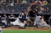 Tampa Bay Rays' Joey Wendle, right, slides past New York Yankees catcher Gary Sanchez to score on a Travis d'Arnaud double during the seventh inning of a baseball game Tuesday, June 18, 2019, in New York. (AP Photo/Frank Franklin II)