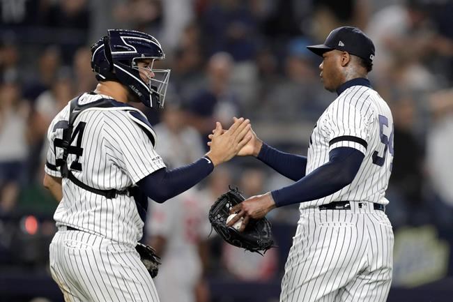 New York Yankees catcher Gary Sanchez, left, and relief pitcher Aroldis Chapman congratulate on another after the Yankees defeated the Boston Red Sox 4-1 during a baseball game Friday, May 31, 2019, in New York. (AP Photo/Julio Cortez)
