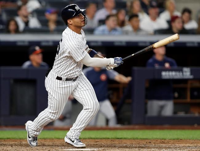 New York Yankees' Gleyber Torres watches his two-run home run during the seventh inning of the team's baseball game against the Houston Astros, Friday, June 21, 2019, in New York. (AP Photo/Kathy Willens)