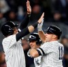 New York Yankees Brett Gardner (11) celebrates with the Yankees Mike Tauchman, left, and Austin Romine, center, after hitting a seventh-inning grand slam in baseball game against the Boston Red Sox, Wednesday, April 17, 2019, in New York. (AP Photo/Kathy Willens)