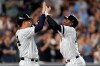 New York Yankees' Gary Sanchez, left, congratulates Didi Gregorius after scoring on Gregorius' grand slam during the eighth inning of the team's baseball game against the Tampa Bay Rays, Tuesday, July 16, 2019, in New York. (AP Photo/Kathy Willens)