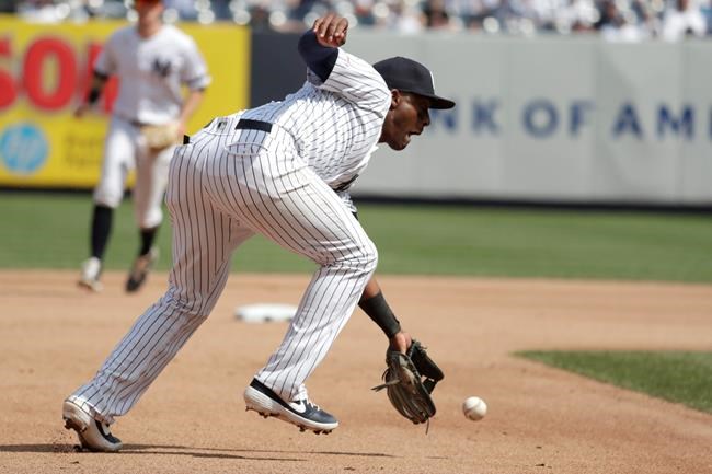 New York Yankees third baseman Miguel Andujar fields a ground ball hit by Minnesota Twins' Nelson Cruz during the seventh inning of a baseball game, Saturday, May 4, 2019, in New York. Andujar overthrew second base while trying to conduct a double play and Twins' Mitch Garver was able to move to third base on the error. (AP Photo/Julio Cortez)