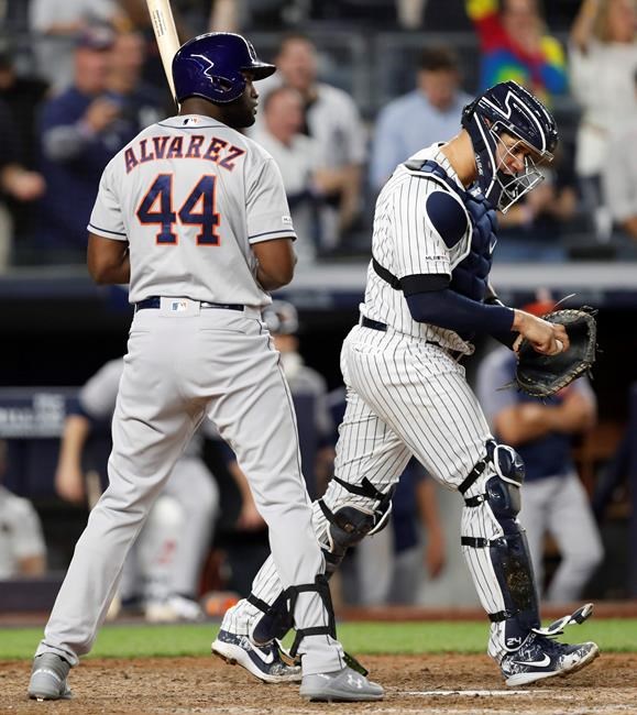 Houston Astros designated hitter Yordan Alvarez (44) stands at the plate after he struck out looking, stranding two runners and ending the game, as the New York Yankees defeated the Astros 4-2 in a baseball game Friday, June 21, 2019, in New York. Yankees catcher Gary Sanchez heads to the mound. (AP Photo/Kathy Willens)