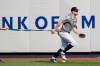 New York Yankees' Giancarlo Stanton, who has been out the much of the season with various injuries, trains with a resistance band in the outfield before a baseball game between the Yankees and the Texas Rangers, Wednesday, Sept. 4, 2019, in New York. (AP Photo/Kathy Willens)