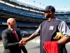 In this Wednesday, May 8, 2019 photo, former Liverpool goalkeeper Bruce Grobbelaar, left, speaks to New York Yankees pitcher CC Sabathia as the pair met on the field at Yankee Stadium in New York. When Grobbelaar celebrated at Anfield on April 28, 1990, he never thought it would be Liverpool's last league title in three decades. (AP Photo/Kathy Willens)