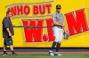 New York Yankees' Giancarlo Stanton, right, who has been out the much of the season with various injuries, takes a break as he works with a trainer and a resistance band in the outfield before a baseball game between the Yankees and the Texas Rangers, Wednesday, Sept. 4, 2019, in New York. (AP Photo/Kathy Willens)