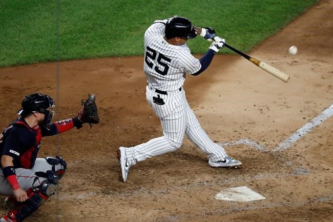 New York Yankees' Gleyber Torres (25) hits a solo home run during the fifth inning in the second baseball game of the team's doubleheader against the Boston Red Sox, Saturday, Aug. 3, 2019, in New York. Red Sox catcher Christian Vazquez is behind the plate. (AP Photo/Kathy Willens)