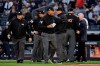 Second base umpire Kerwin Danley (44) motions for a change of the home plate umpire as home plate umpire Jeff Nelson leaves the game after the fourth inning of Game 3 of baseball's American League Championship Series between the New York Yankees and the Houston Astros, Tuesday, Oct. 15, 2019, in New York. Nelson was hit with a foul tip earlier in the game. (AP Photo/Frank Franklin II)