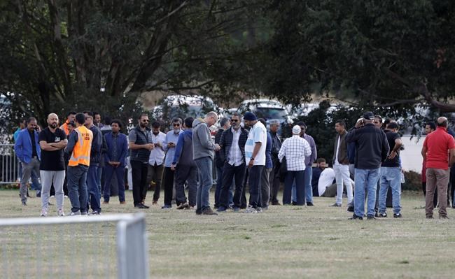People wait for the start of funeral services in Christchurch, New Zealand, Wednesday, March 20, 2019. The first two burials of the victims from last week’s mosque shootings are scheduled to take place Wednesday morning. (AP Photo/Mark Baker)