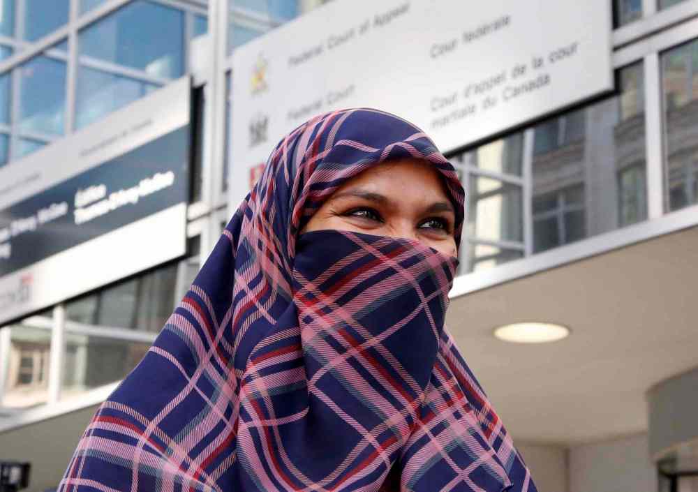 THE CANADIAN PRESS/ Patrick Doyle
Zunera Ishaq talks to reporters outside the Federal Court of Appeal after her case was heard on whether she can wear a niqab while taking her citizenship oath, in Ottawa on Tuesday, September 15, 2015.