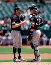 Chicago White Sox pitcher Dylan Covey, left, speaks with catcher Zack Collins in the first inning of a baseball game against the Oakland Athletics, Saturday, July 13, 2019, in Oakland, Calif. (AP Photo/Ben Margot)