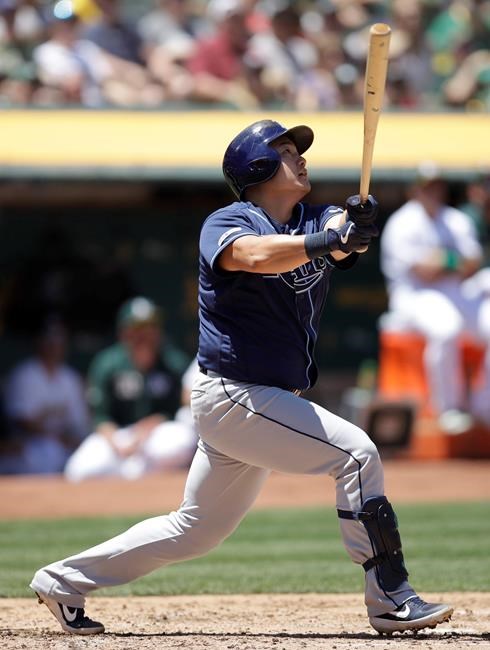 Tampa Bay Rays' Ji-Man Choi watches his RBI sacrifice fly off Oakland Athletics' Mike Fiers during the third inning of a baseball game Saturday, June 22, 2019, in Oakland, Calif. (AP Photo/Ben Margot)