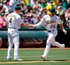 Oakland Athletics' Matt Chapman, right, is congratulated by third base coach Matt Williams (4) after hitting a home run off Tampa Bay Rays' Yonny Chirinos during the third inning of a baseball game Saturday, June 22, 2019, in Oakland, Calif. (AP Photo/Ben Margot)