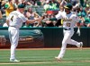 Oakland Athletics' Marcus Semien, right, is congratulated by third base coach Matt Williams (4) after hitting a home run off Texas Rangers pitcher Pedro Payano in the third inning of a baseball game Sunday, July 28, 2019, in Oakland, Calif. (AP Photo/Ben Margot)