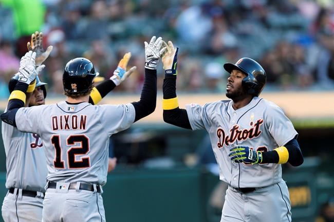 Detroit Tigers' Travis Demeritte, right. celebrates with Brandon Dixon (12) after scoring against the Oakland Athletics during the second inning of a baseball game Saturday, Sept. 7, 2019 in Oakland, Calif. (AP Photo/John Hefti)