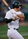 Oakland Athletics' Matt Olson swings for an RBI-double off Baltimore Orioles pitcher Andrew Cashner in the first inning of a baseball game Monday, June 17, 2019, in Oakland, Calif. (AP Photo/Ben Margot)