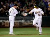 Oakland Athletics' Sean Murphy, right, is congratulated by third base coach Matt Williams after hitting a home run off Los Angeles Angels' Jake Jewell during the fifth inning of a baseball game Wednesday, Sept. 4, 2019, in Oakland, Calif. (AP Photo/Ben Margot)