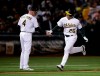 Oakland Athletics' Matt Chapman, right, is congratulated by third base coach Matt Williams after hitting a home run against the Houston Astros during the sixth inning of a baseball game Wednesday, April 17, 2019, in Oakland, Calif. (AP Photo/Ben Margot)