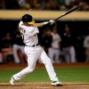 Oakland Athletics' Marcus Semien swings for a two-run double off Texas Rangers' Lance Lynn in the fourth inning of a baseball game, Tuesday, April 23, 2019, in Oakland, Calif. (AP Photo/Ben Margot)