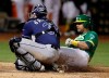 Tampa Bay Rays catcher Travis d'Arnaud, left, tags out Oakland Athletics' Khris Davis during the sixth inning of a baseball game Friday, June 21, 2019, in Oakland, Calif. (AP Photo/Ben Margot)