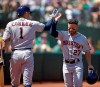 Houston Astros' Jose Altuve, right, is congratulated by Carlos Correa (1) after scoring against the Oakland Athletics in the third inning of a baseball game Saturday, Aug. 17, 2019, in Oakland, Calif. (AP Photo/Ben Margot)