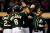 Oakland Athletics' Chris Herrmann, right, celebrates after hitting a grand slam off Minnesota Twins' Jake Odorizzi in the fourth inning of a baseball game Tuesday, July 2, 2019, in Oakland, Calif. (AP Photo/Ben Margot)